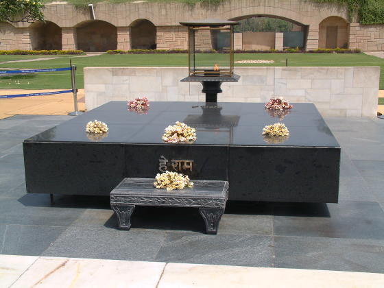 A black stone slab with flowers and a lantern on top